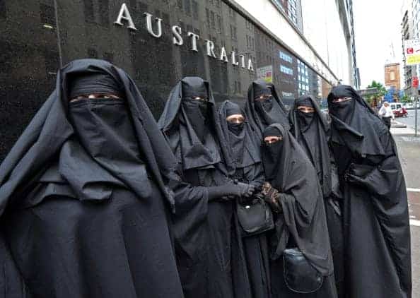Men and women dressed in burqas from the