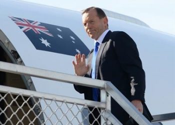Tony Abbott boarding a flight to Jakarta to discuss asylum seeker issues