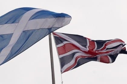 Scotland's Saltire flag (L) and Britain's Union flag are pictured in London, on September 16, 2014, ahead of the referendum on Scotland's independence. The leaders of the three main British parties on Tuesday issued a joint pledge to give the Scottish parliament more powers if voters reject independence, in a final drive to stop the United Kingdom splitting.  AFP PHOTO / CYRIL VILLEMAIN        (Photo credit should read CYRIL VILLEMAIN/AFP/Getty Images)