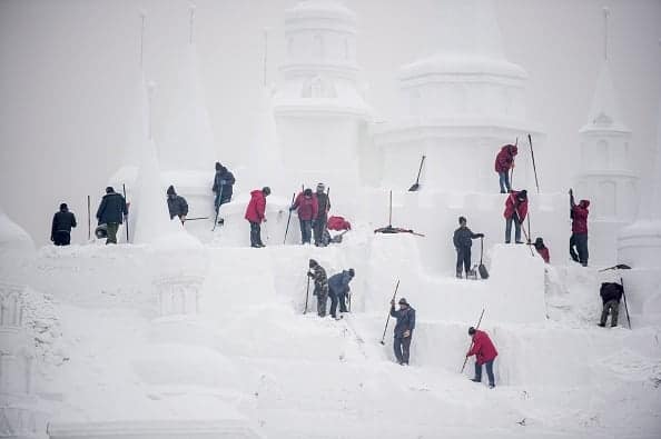 Ice sculptors carve a snow sculpture, on January 4, 2015 at the China Ice and Snow World on the eve of the opening ceremony of the Harbin International Ice and Snow Festival in China. (FRED DUFOUR/AFP/Getty Images)