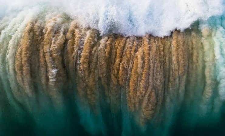 Detail from Reed Plummer’s photograph Surge, in which a breaking wave drops tons of water even as it pulls tons of sand from the sea bed. (South Australian Museum)