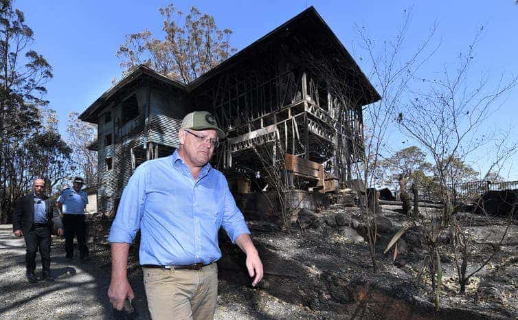 Prime Minister Scott Morrison inspecting a burnt-out property in the Gold Coast hinterland in September 2019. Mr Morrison has offered “thoughts and prayers” to those affected by the fires. (Dave Hunt/AAP)