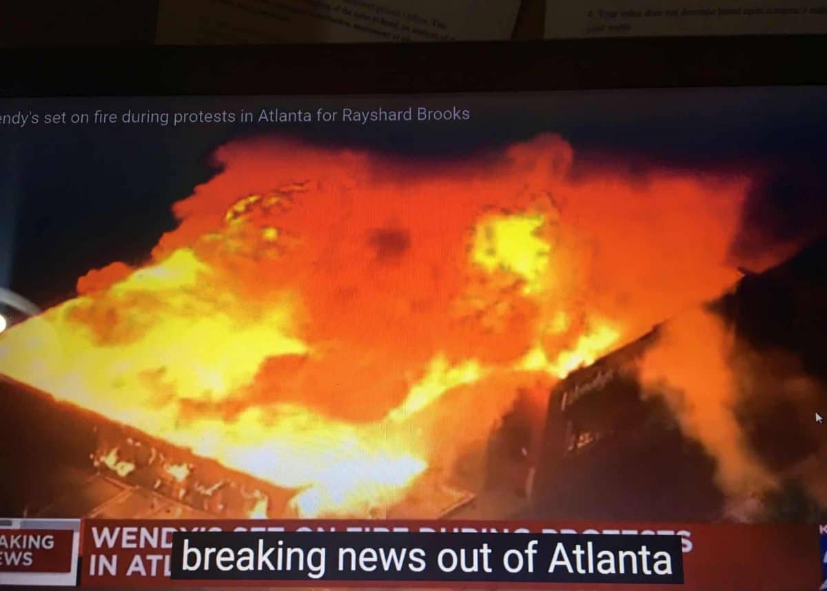 TV news channel coverage of Wendy's outlet in Atlanta set ablaze by protesters
