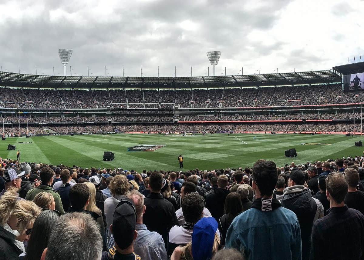 Fans at the MCG await the teams ahead of the 2018 Grand Final. Photo credit: Wikimedia Commons.
