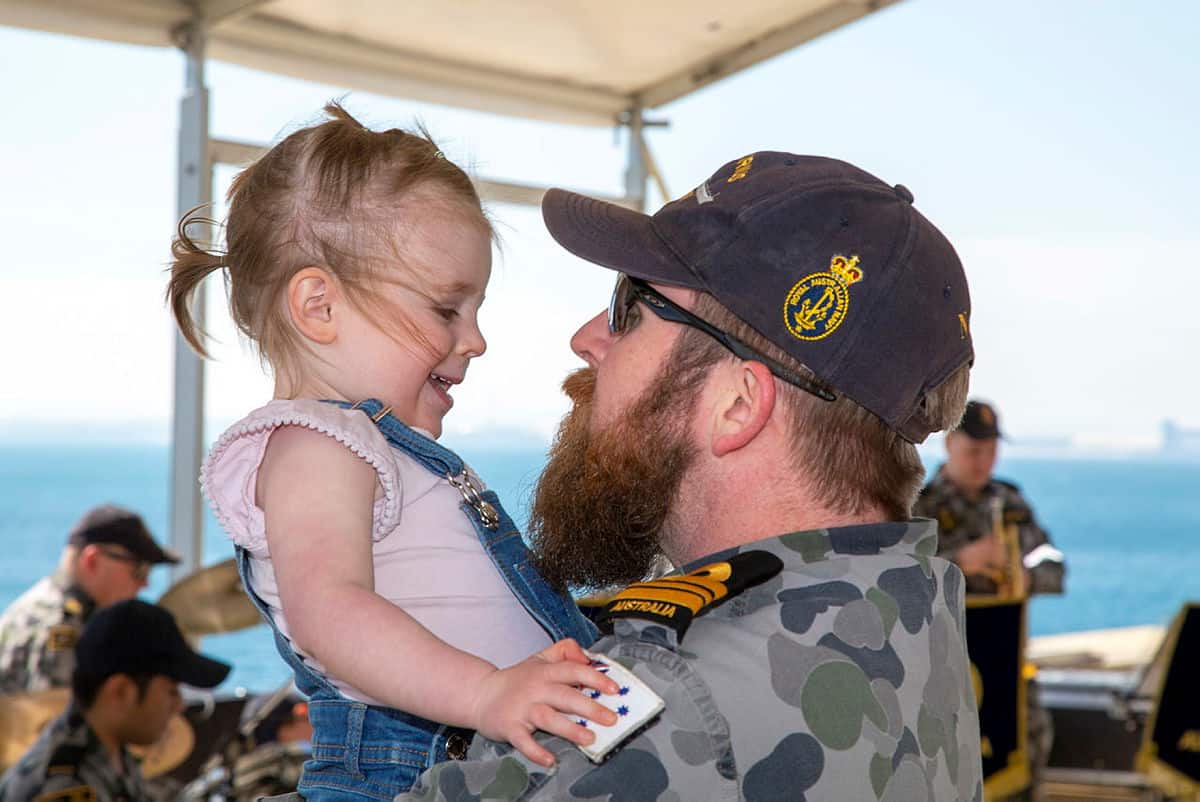Lieutenant Commander Mitchell Thomas greets his daughter Emily after HMAS Sirius returned to Fleet Base West in WA. Photo credit: RAN