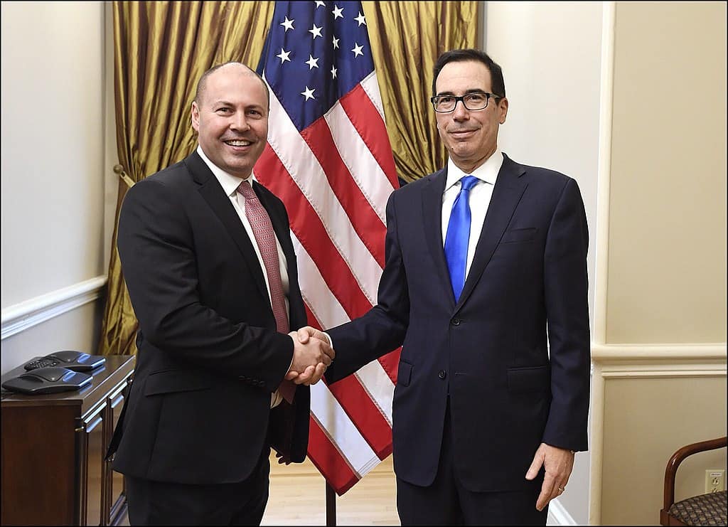 Josh Frydenberg (left) with US Secretary of the Treasury, Steven Mnuchin, during a meeting of the IMF in Washington DC in 2019.  Photo credit: Wikimedia Commons