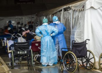Health care workers and patients in the temporary outside area Steve Biko Academic Hospital created to screen and treat suspected Covid-19 cases in Pretoria. Alet Pretorius/Gallo Images via Getty Images