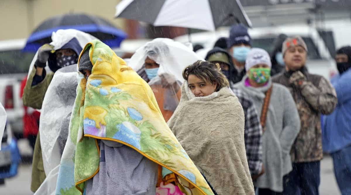 Waiting in line in freezing rain to fill propane tanks in Houston, Texas, Feb. 17, 2021. AP Photo/David J. Phillip