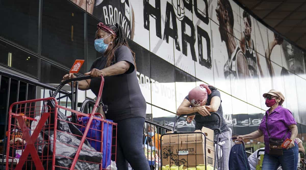 Americas’ financial desperation can be seen in the soaring demand for food assistance. AP Photo/John Minchillo