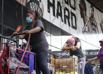 Americas’ financial desperation can be seen in the soaring demand for food assistance. AP Photo/John Minchillo