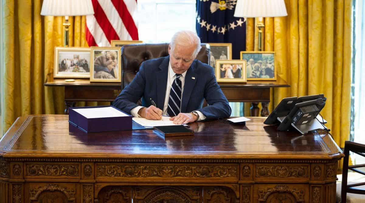 President Joe Biden signs the $1.9 trillion COVID relief bill into law Thursday. Doug Mills-Pool/Getty Images