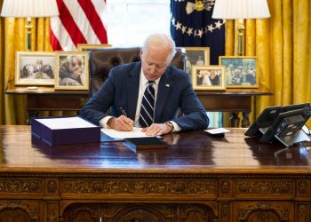 President Joe Biden signs the $1.9 trillion COVID relief bill into law Thursday. Doug Mills-Pool/Getty Images