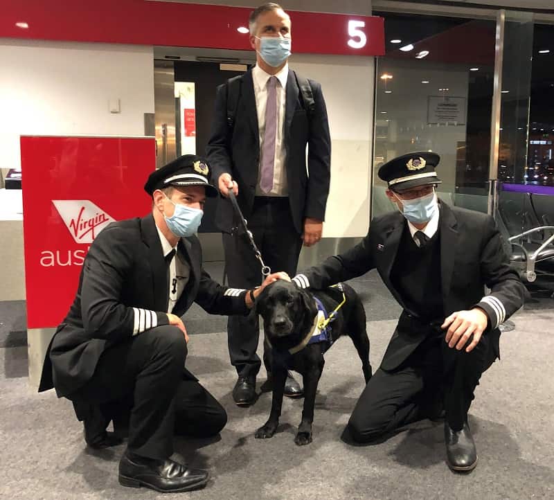 Odie and owner Chris Edwards with members of the crew on his final flight