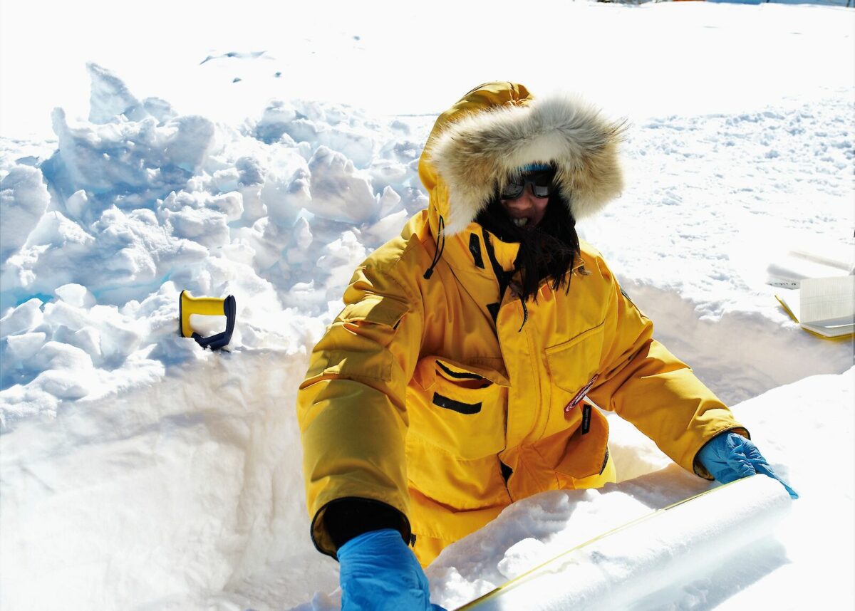 A scientist measuring the ice core at Aurora Basin North in Antarctica. Photo credit: Tony Fleming/AAD