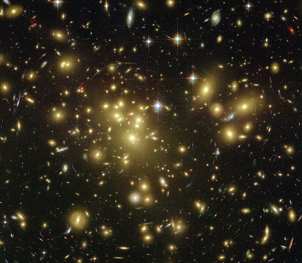 Strong gravitational lensing as observed by the Hubble Space Telescope in Abell 1689 indicates the presence of dark matter. Photo credit: NASA via Wikipedia